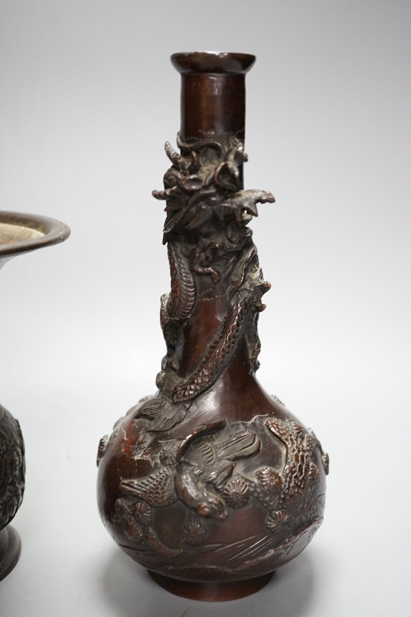 A pair of Japanese Meiji period bronze ‘dragon’ bottle vases and another, 21cm